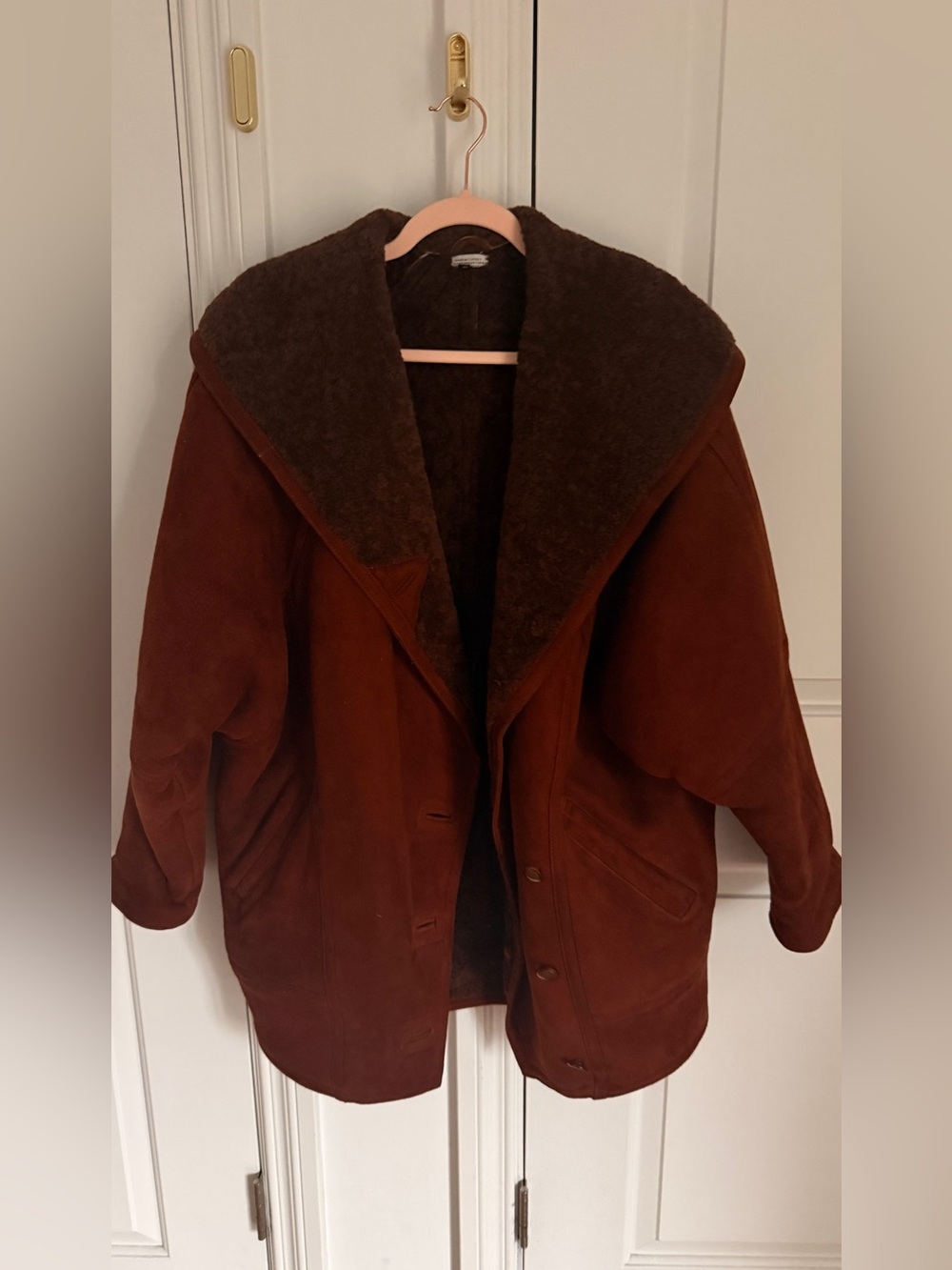 chocolate brown shearling coat with a wide oversized shearling collar.